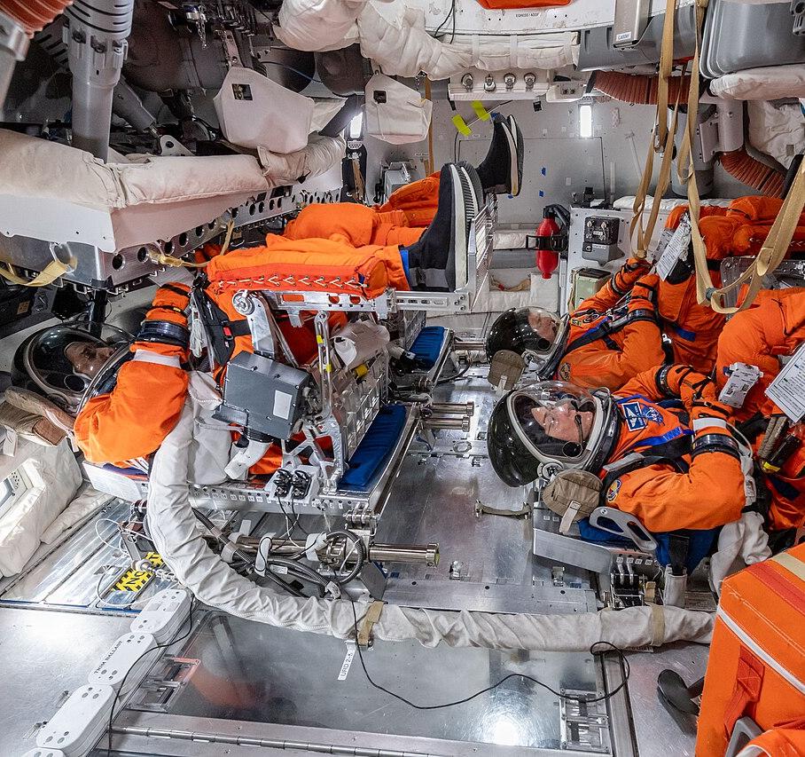 The crew of Artemis II inside a mock-up of Orion