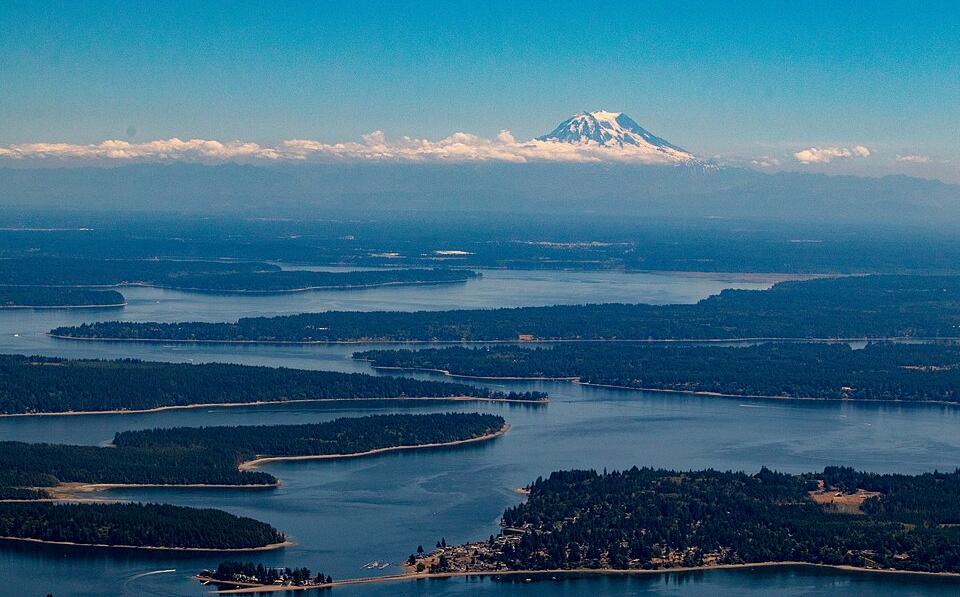 Mount Rainier, an active volcano in the Cascade Range, with Puget Sound in the foreground