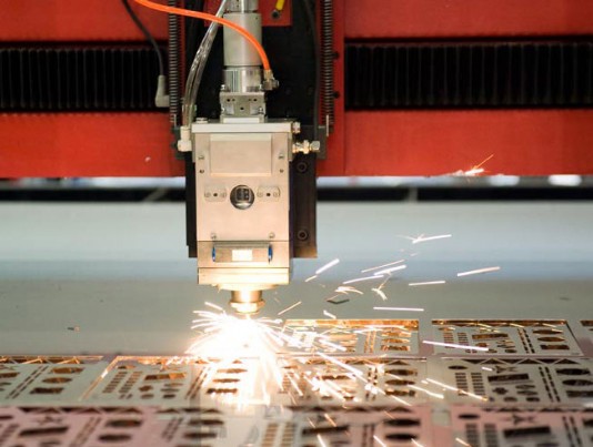 An industrial laser cutter in operation