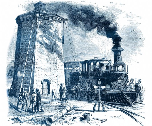 A steam locomotive takes on water