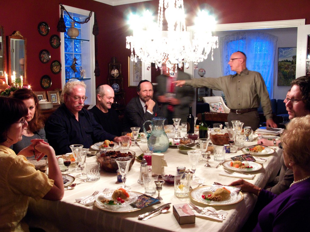 A Jewish family sit at the seder table at Passover