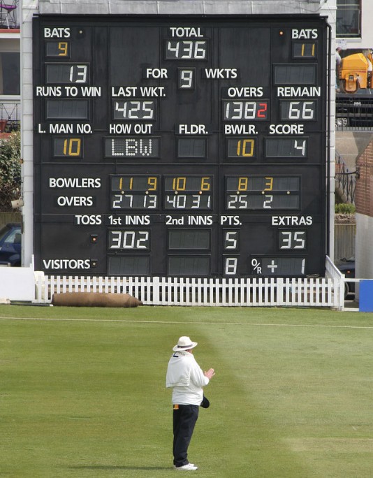An umpire and scoreboard