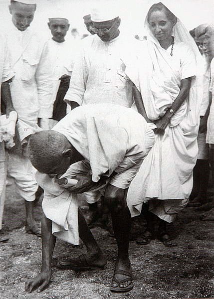 Gandhi picking salt from the beach, 1930