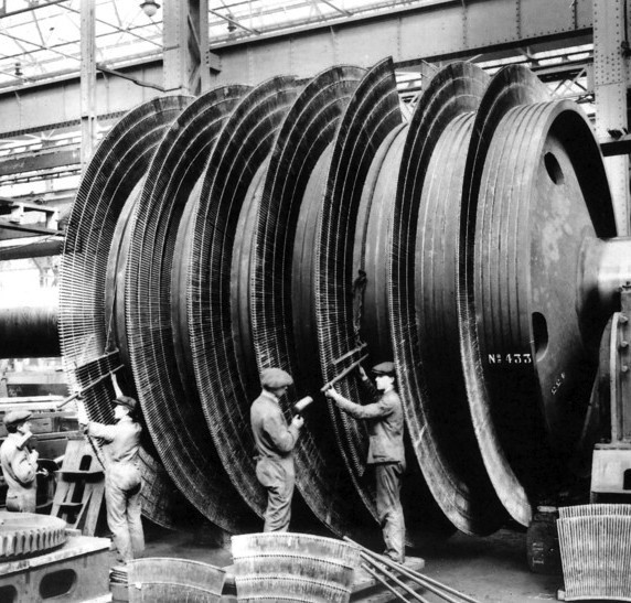 Workmen assembling turbine engines on a ship, 1915